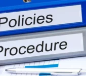 A stock photograph of binders of policies and procedures.